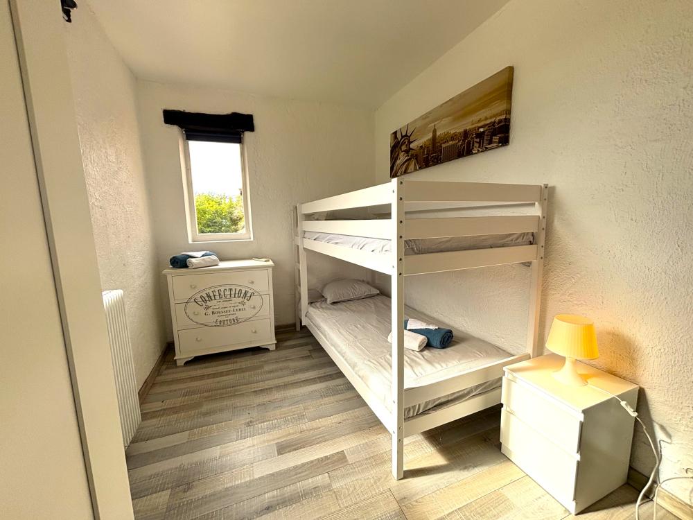 The fourth bedroom is furnished with a bunked 