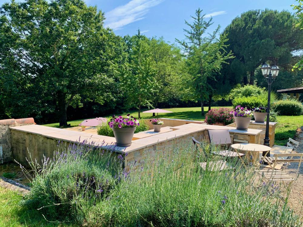 The house is surrounded by a flowered huge mature garden 