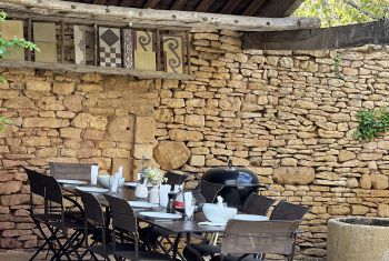 The outdoor dining area is set under the breadoven terrace 
