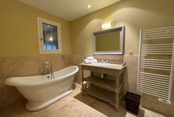 and its large bathroom with its elegant bathtub 