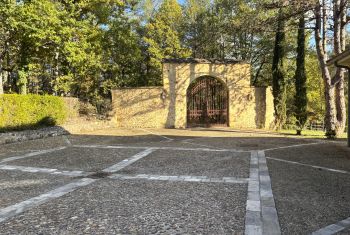 The parking area and beautiful iron gate
