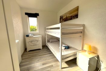 The fourth bedroom is furnished with a bunked 