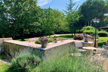 The house is surrounded by a flowered huge mature garden 